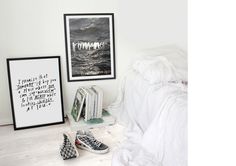 a bedroom with white walls and pictures on the wall next to it, including shoes