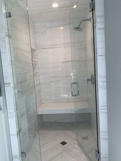 a walk in shower sitting inside of a bathroom