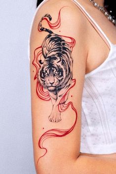 a woman with a tiger tattoo on her arm