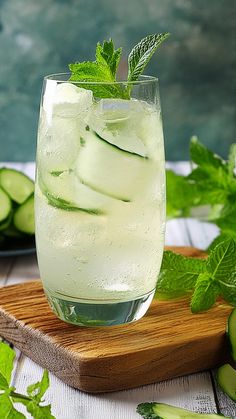 cucumber and mint water in a glass on a cutting board