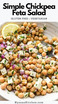 a white bowl filled with chickpea and feta salad next to a lemon wedge