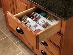 an open drawer in the middle of a kitchen counter