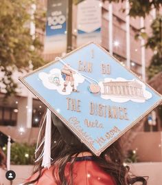 a woman wearing a blue graduation cap that says i can do the distance