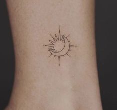 a small sun and moon tattoo on the side of a woman's foot,