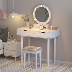 a white vanity table with a mirror and stool in front of it on a carpeted floor