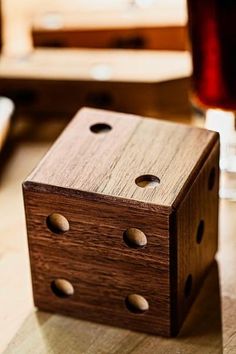 a wooden dice sitting on top of a table