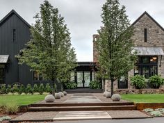 a large black house with stone steps leading up to it