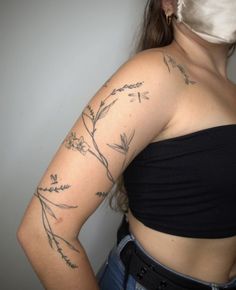 a woman with tattoos on her arms and shoulder