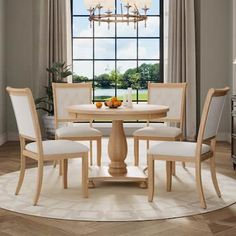 a round dining table with four chairs around it