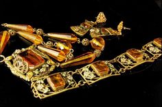 "This is a very beautiful, old and unique ART NOUVEAU NEIGER CZECH CRYSTAL BRASS ENAMEL c, 1920 bracelet and necklace set. The set has a marvelous Art Nouveau style, enamel, flower decoration, faceted citrine crystal, brass. The set has a very extravagant and elegant feel to it. The bracelet measures 7 1/4\" x 3/4\", necklace 15 3/4\" long and 1 1/2\" x 1\" center. The set is in very good condition. 0.7 BR" Antique Jeweled Jewelry For Formal Occasions, Antique Formal Jewelry, Antique Gold Evening Jewelry, Antique Gold Jewelry For Evening, Gold Hallmarked Art Deco Jewelry, Collectible Art Nouveau Yellow Gold Jewelry, Gold Art Deco Hallmarked Jewelry, Antique Brass Jewelry For Evening, Antique Brass Jewelry For Evening Wear