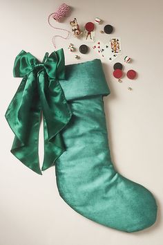 a green christmas stocking laying on top of a table with other items around it