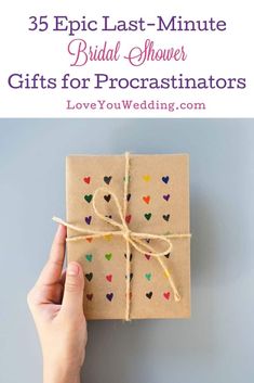 a hand holding a wrapped gift box with hearts on it and the words 35 epic last - minute bridal shower gifts for procrastinators