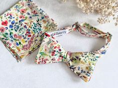 "Beautifully hand made floral self tie bow tie and matching pocket square...a perfect gift for bowties lovers/collectors, gift for men for special occasions such as Anniversary, Birthday, Christmas and so on.. Painted in delicate watercolours, \"Felda\", Tana Lawn Cotton by Liberty of London has a soft and romantic feel, featuring an array of meadow flowers including irises, poppies and daisies. Tana Lawn Cotton offers fluidity with a silk-like touch, unique print quality and striking colour vib Multicolor Bow Tie For Gift, Summer Pocket Square For Suit And Tie As Gift, Summer Gift Pocket Square For Suit And Tie, Summer Gift Pocket Square Suit Accessories, Spring Bow Tie As Gift, Elegant Spring Bow Tie For Gift, Elegant Spring Bow Tie As A Gift, Multicolor Pocket Square With Ties As A Gift, Men Christmas Gift