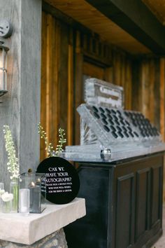 a table with flowers and candles on it in front of a building