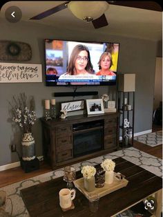 a flat screen tv mounted to the wall in a living room next to a fireplace