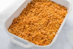 a casserole dish filled with food sitting on top of a white countertop