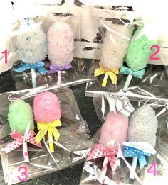 four lollipops wrapped in cellophane with bows and numbers on them