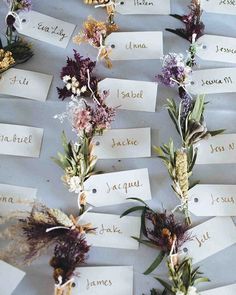 flowers are arranged on top of each other with name tags attached to them