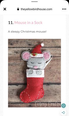 a mouse in a stocking on top of a wooden table next to a phone