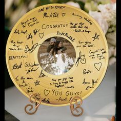 a gold plate with writing on it and a photo in the center surrounded by hearts