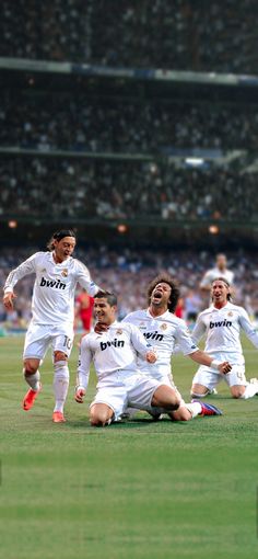 the soccer players are celebrating on the field