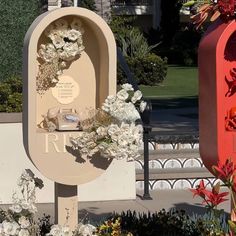 two mailboxes are decorated with white flowers