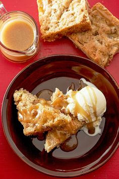 a plate topped with ice cream next to two slices of bread