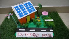 a cake made to look like a house with a solar panel on the roof that says eco friendly house