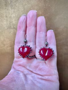 These glass heart earrings are individually handmade from a vibrant red and metallic black glass. The red in this glass goes from a beautiful dark garnet color to bright cherry when it's in direct sunlight.  They are very lightweight and easy to wear. The ear wires are solid sterling silver.  Kiln annealed overnight for strength The ear wires are solid sterling silver.  Feel free to message me if you have any questions. Dark Garnet, Red Heart Necklace, Red Heart Earrings, Mini Earrings, Glass Heart, Vibrant Red, Black Glass, Heart Earrings, Beautiful Earrings