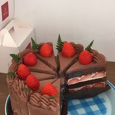 there is a chocolate cake with strawberries on the top and one slice missing from it