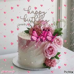 a birthday cake decorated with pink flowers and butterflies