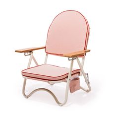 A pink arched folding beach chair with a reddish/dark pink lining around the edge and wood arm rests. Pillow Stack, Pillow Lounger, Beach Furniture, Adventure Essentials, Pink Business, Wardrobe Furniture, Stylish Chairs, Beach Chair, Sling Chair