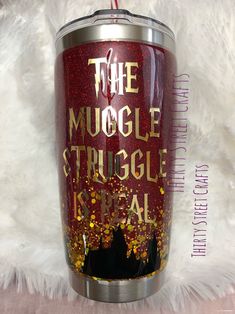 the mugle struggle is real glitter tumbler cup with straw in it on white fur