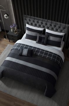 a black and white bed with pillows on it