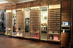 the display case is made out of wood and has multiple shelves with books on them