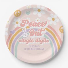 a pink paper plate with peace out single digits written on the front and rainbow design