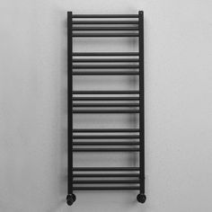 a black towel rack hanging on the wall