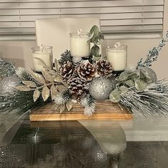 a table topped with candles and christmas decorations