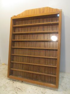 an empty wooden book shelf in a room