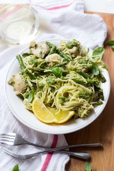 a white plate topped with pasta and broccoli