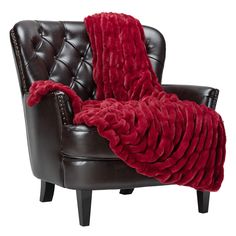 a brown chair with a red blanket on it