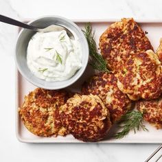 crab cakes with sour cream on a plate