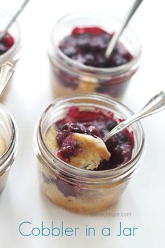 four small jars filled with blueberry cobbler in a jar