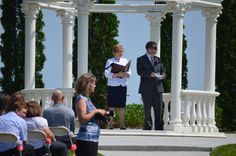 a man and woman are standing at the alter