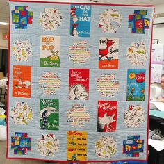 the dr seuss book quilt is hanging up in front of some children's desks