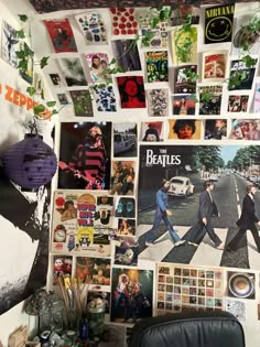 the wall is covered with posters and pictures from the beatles album's past years