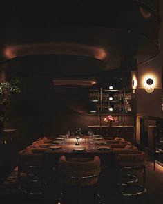 a dimly lit dining room with long tables and chairs