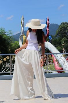 All items are shipped to Thailand Post . Free upgrade to D.H.L Express when you buy 2 or more items . The USA only. Please leave a phone number with orders . Made in 100% cotton soft , light and very comfy . These bell bottom pants have a cute design .They allow you to adjust the bottom of the hemline with 4 ties on the inside of the leg .Tighten the ties to create a draped look , tie loosely for a bell-bottom hemline. A fantastic flare of 50''inches. The pants are half lined with an elastic wai Non-stretch High-waisted Parachute Pants For Summer, High-waisted Pants For Festival, White Non-stretch Wide Leg Harem Pants, Baggy High-waisted Harem Pants For Beach, High Waist Beige Parachute Pants For Summer, Beige High Waist Parachute Pants For Summer, Casual High-waisted Pants For Festival, Casual High-waisted Festival Pants, White Casual Pants For Festival