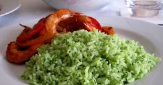 a white plate topped with rice and shrimp