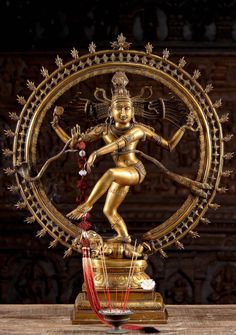 a golden statue is displayed on a table